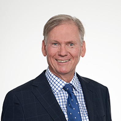 Headshot of RASF Board Member David Davison, smiling and wearing a dark suit, blue tie, and checkered shirt.