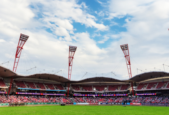 View of ENGIE Stadium with spectators seated and a clear blue sky overhead.