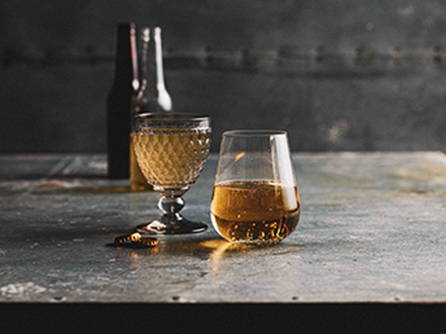 Two glasses of golden beer on a silver rustic table at the Sydney Royal Beer & Cider Show.