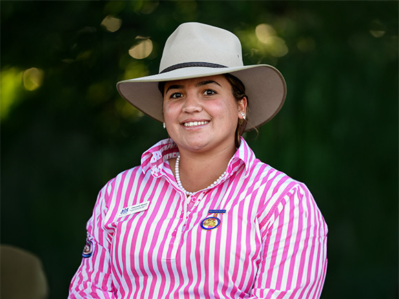 Headshot of 2025 finalist Chennelle Winsor, a woman with dark hair, wearing pearl earrings and a wide-brimmed hat.