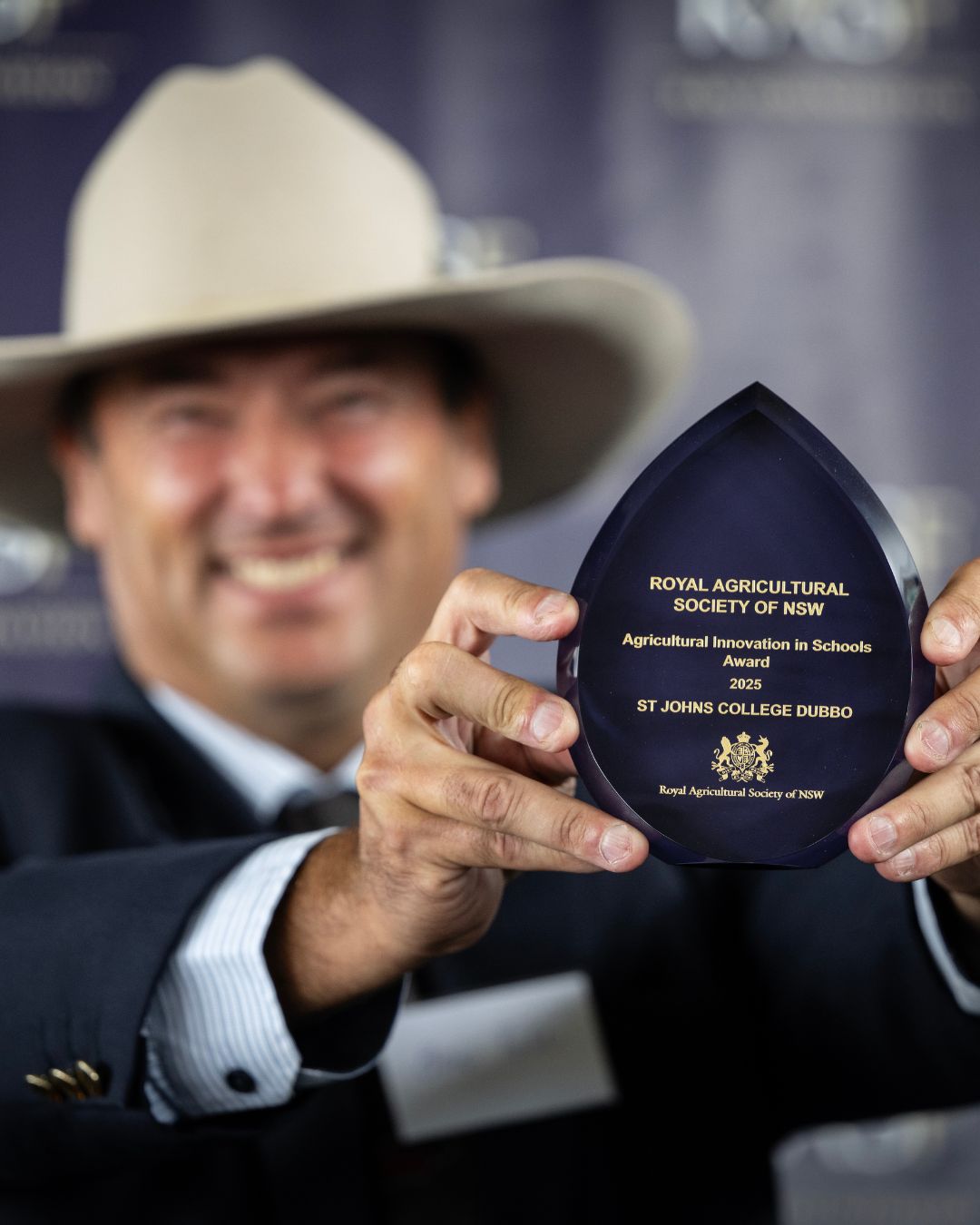 Finalist holding a trophy engraved “Agricultural Innovation in Schools Award 2025 – St Johns College Dubbo.”
