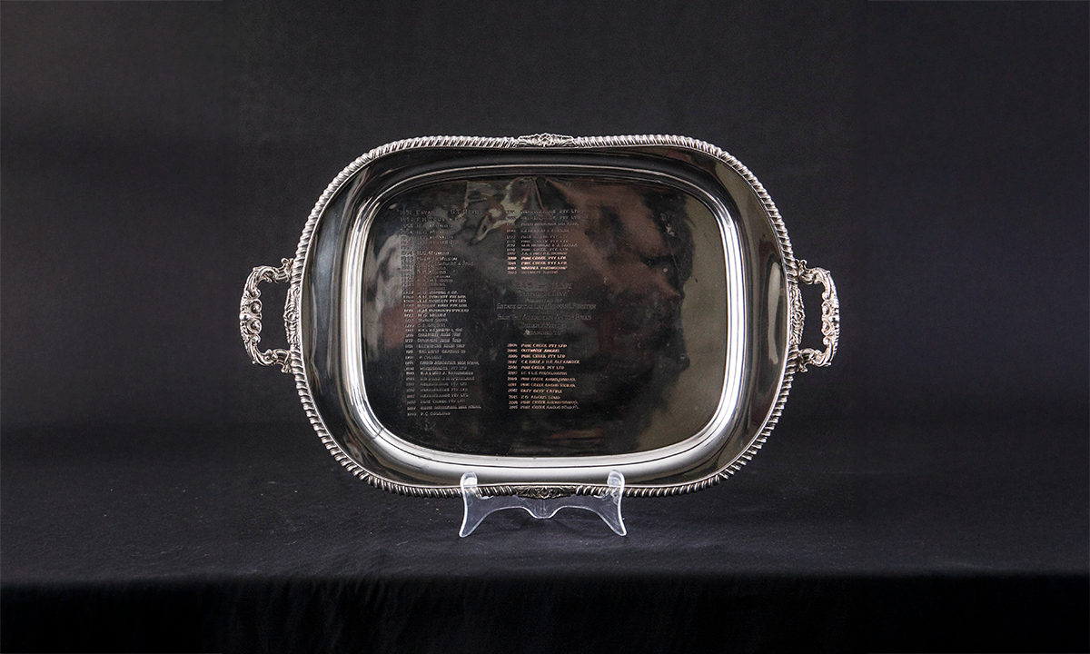 Rectangular tray with rounded edges, decorative border, and two foliate handles. First awarded in 1951.