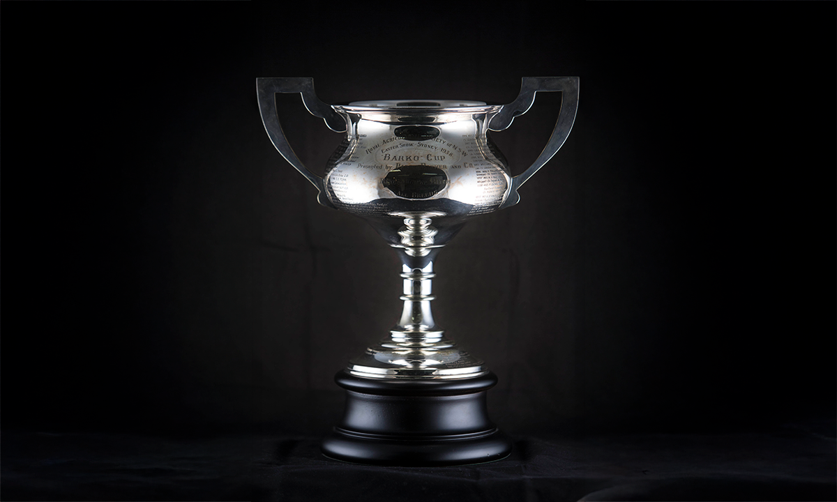 Silver twin handled cup raised on a round black base. “Royal Agricultural Society of NSW, Easter Show – Sydney, 1938. ‘Barko’ Cup” is engraved on the front of the cup. First awarded 1937.