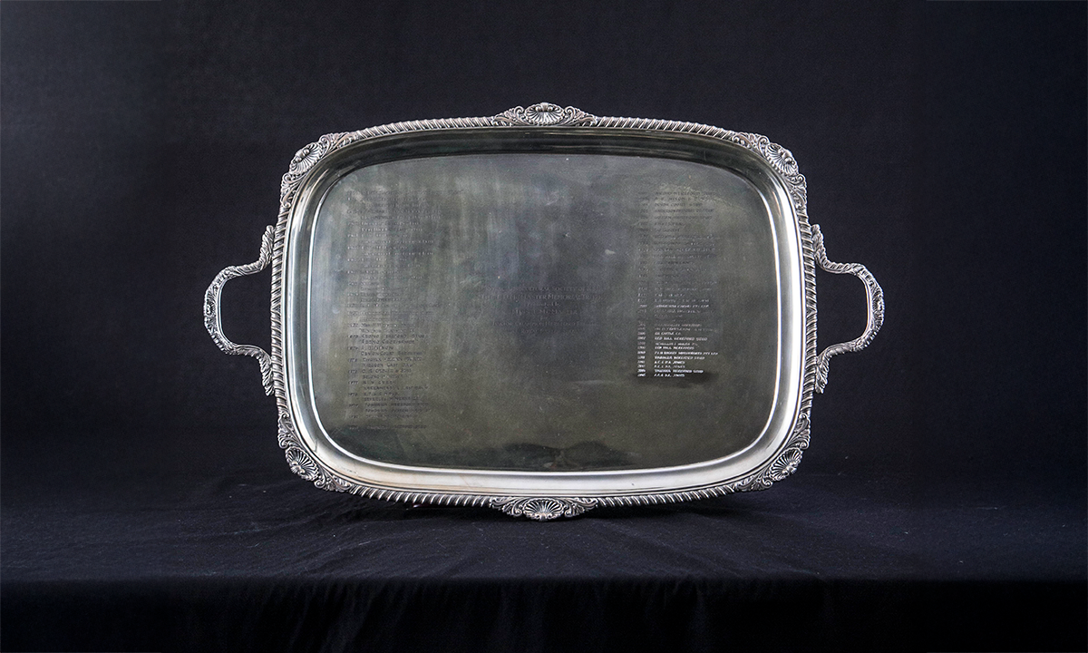 Silver twin handled tray of rectangular form with detailed, curved edges. First presented in 1960. 