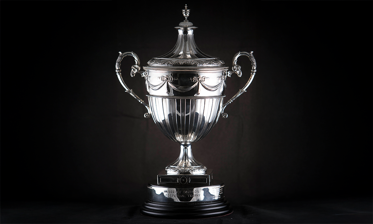 An antique Edwardian English Sterling Silver Presentation Cup and Cover with ribbon detailing. First presented in 2011. 