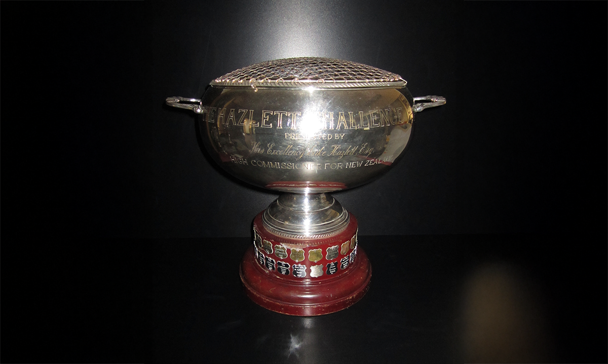 Large silver punch bowl, with two handles and gilt grill to the top, raised on a circular wooden base. First awarded in 1969.