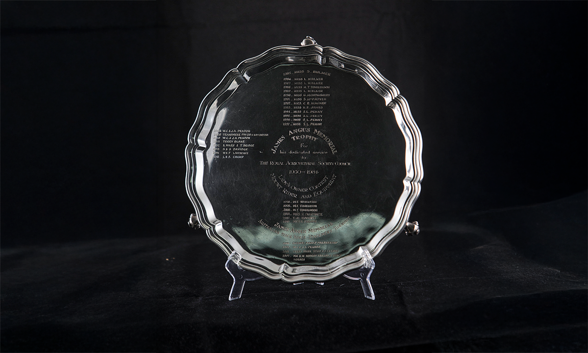 Round silver plate with scalloped edges, raised on scroll feet. The name of the trophy and winners are engraved on the centre of the plate. First presented in 1985.