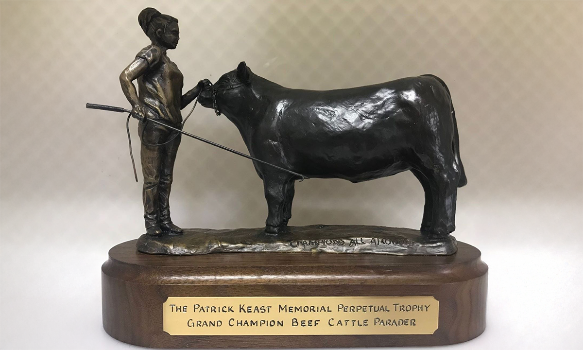 Bronze sculpture of a young female handler and bull. The sculpture sits atop a polished timber base. First awarded in 2019.