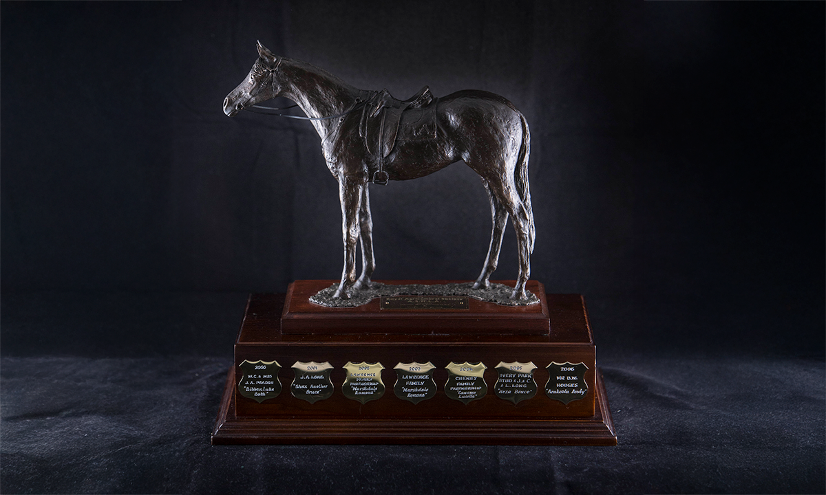 Bronze figure of a horse with saddle and harness, mounted on a tiered rectangular wooden base. First awarded in 2000.