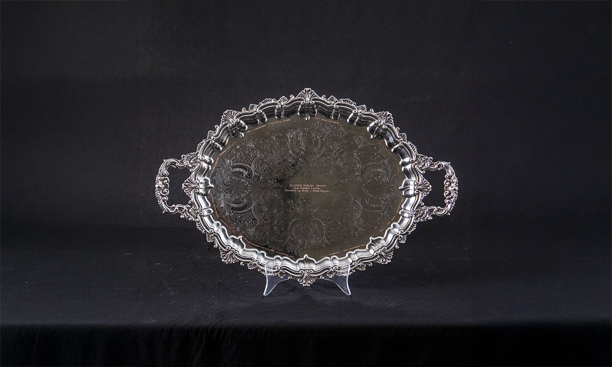 Silver tray of twin handled oval form with a shell and foliate embossed border and engraved centre. First presented in 1997. 