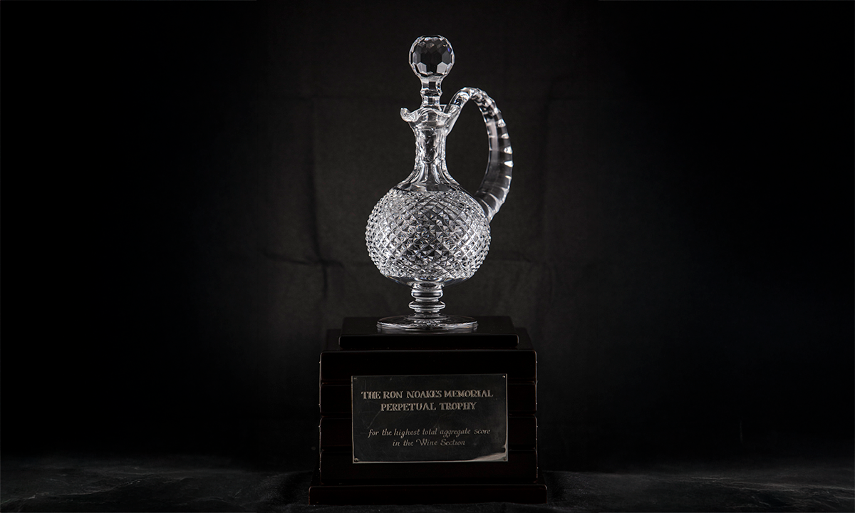 A crystal decanter with faceting details on the handle and body, mounted on a square plinth. First awarded 2009.