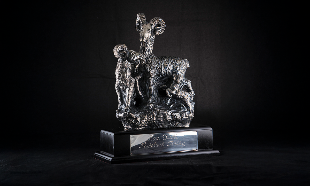 Silver sculpture of two goats mounted on wooden plinth. First presented in 2009. 