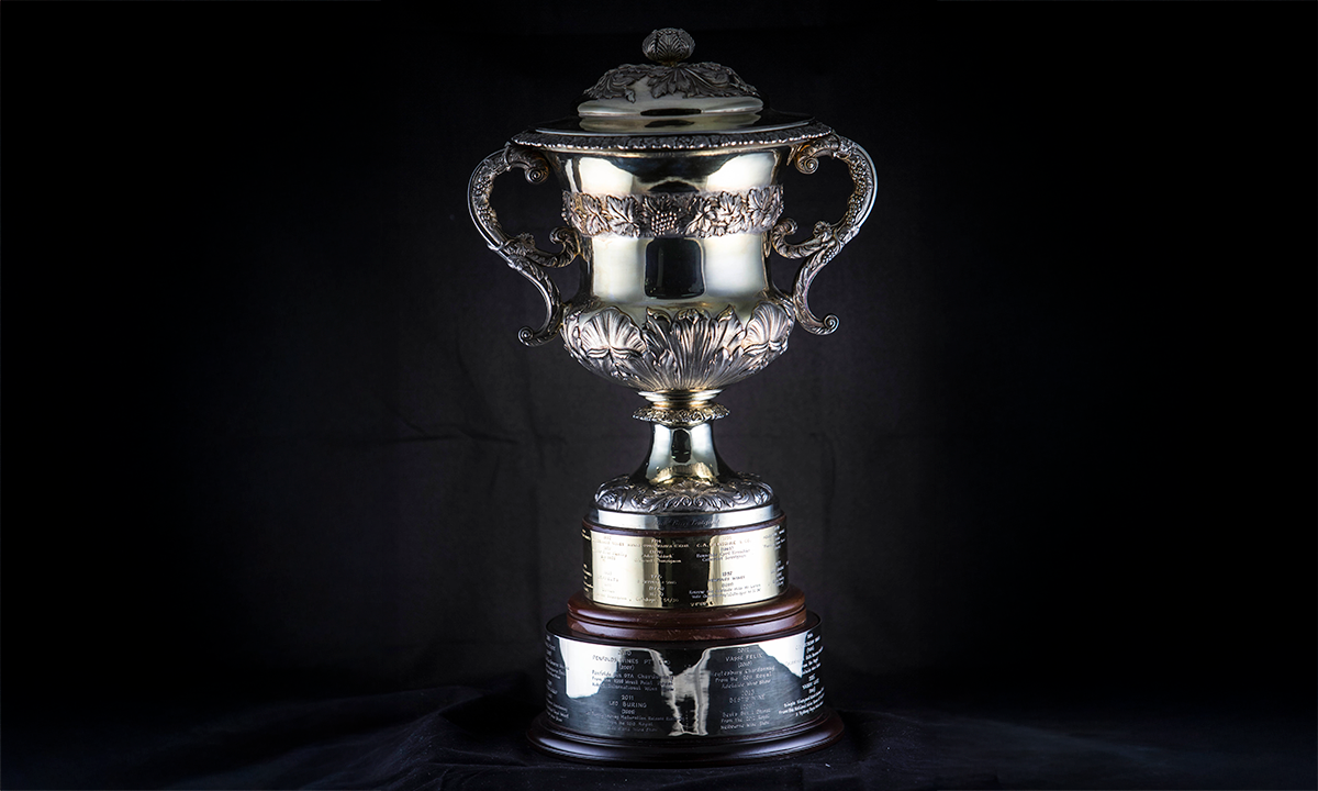 Wine cooler and cover with a richly embossed body with a band of fruiting vine and acanthus leaves. Two scroll handles decorated with applied grape and vine, the lid adorned with applied acanthus leaves and acanthus leaf knop, raised on a circular base. First awarded in 1988.