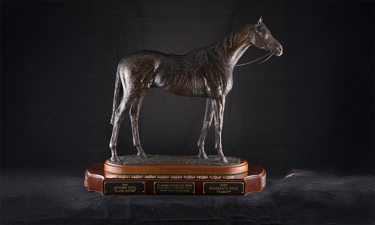 Bronze figure of a horse wearing a saddle and harness, mounted on a wooden base. First awarded in 1991.